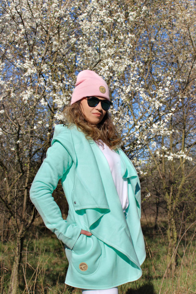 Surf Girl Wearing Aloha Surf Coat in Spring with pink beanie hat