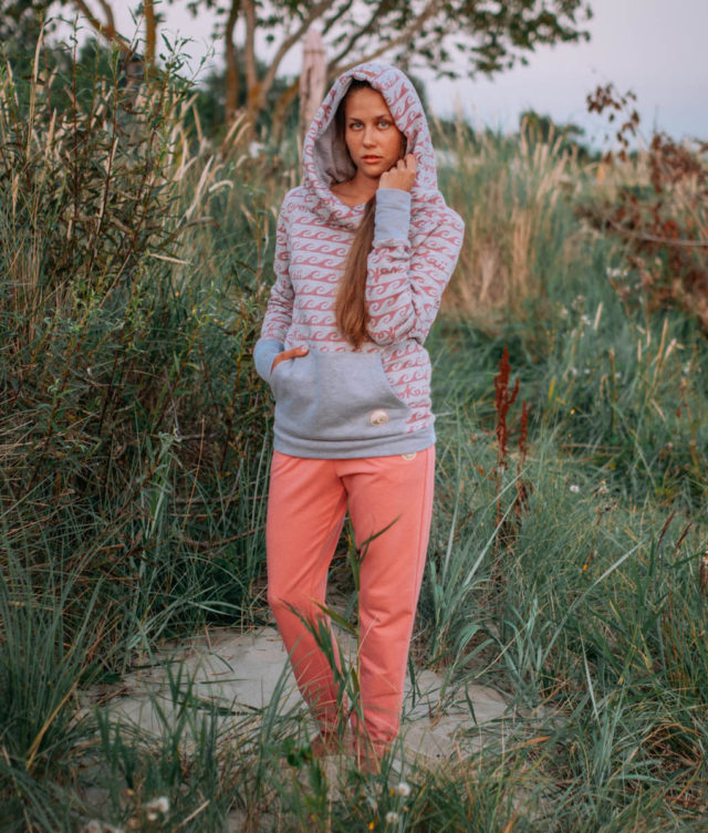 Surf girl wearing surf hoodie bombora at the baltic sea