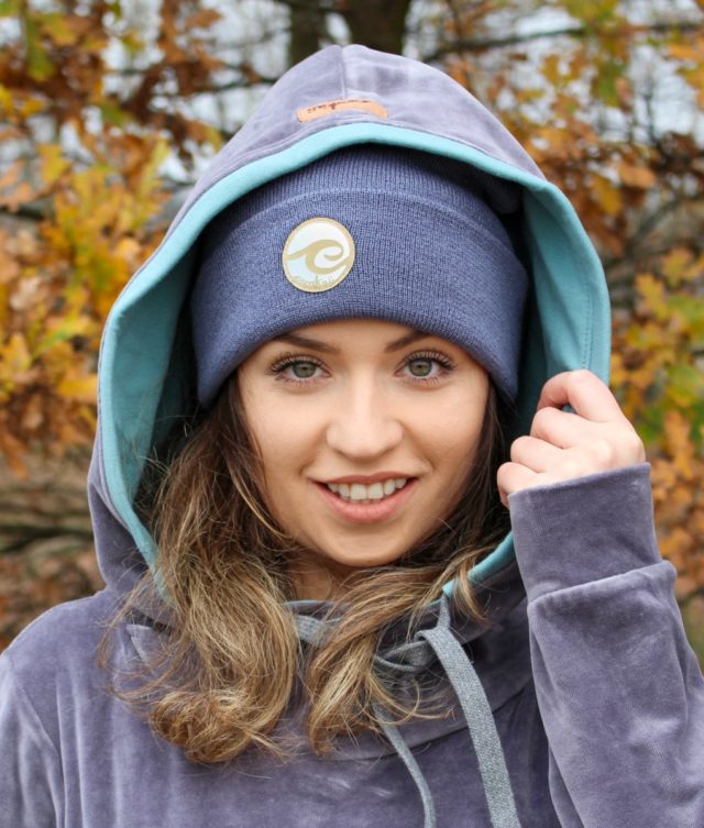 Surf beanie in anthracite colour worn by surf girl in autumn forest with velvet snug surf hoodie outfit.